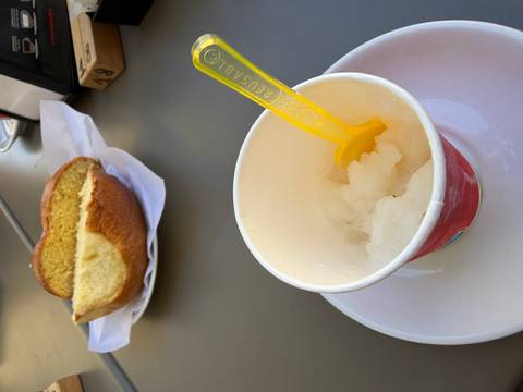 A cup of refreshing Sicilian granita with a brioche bun ready to be enjoyed for breakfast.