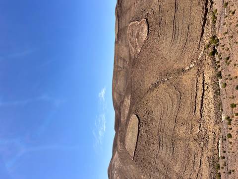 Barren rocky plateau under a cloudless bright blue sky in the Moroccan desert