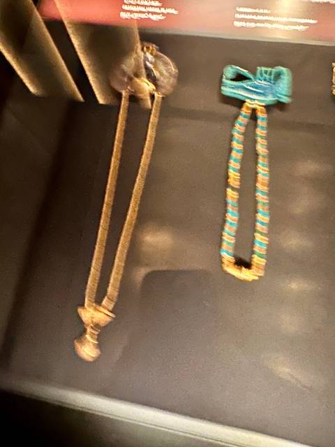 Out-of-focus display case with ancient jewelry pieces