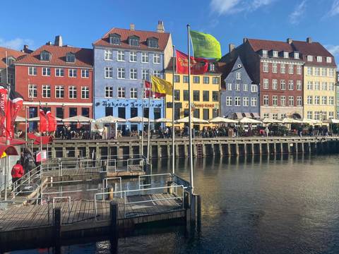 Colorful historic buildings and lively cafés line the opposite side of Copenhagen’s Nyhavn canal.