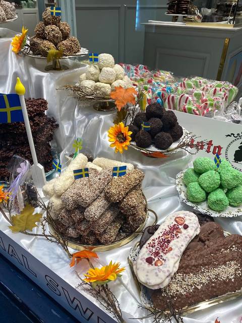 Assortment of Swedish sweets and coconut balls decorated with small Swedish flags.