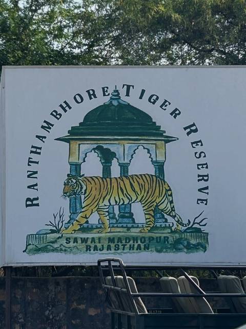Illustrated signboard for Ranthambhore Tiger Reserve featuring a tiger beneath an arch.