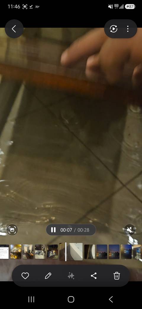 Very blurry image of a wet dark surface with indistinct reflections.