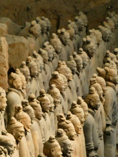 Row upon row of Terracotta Warrior figures captured in a slightly soft, grainy image.