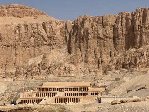 Mortuary temple of Hatshepsut nestled against towering desert cliffs in Luxor