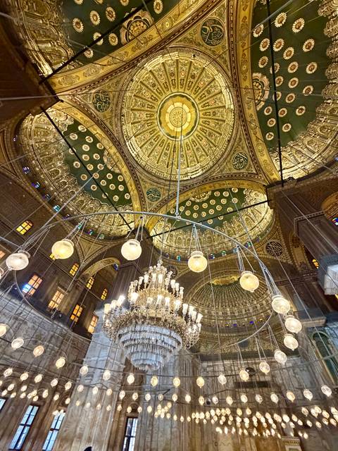 Opulent golden domed ceiling and chandelier inside the Muhammad Ali Mosque in Cairo