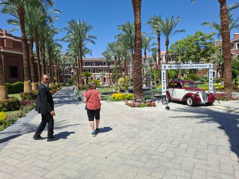 Guests strolling through the lush gardens of the historic Old Cataract Hotel.