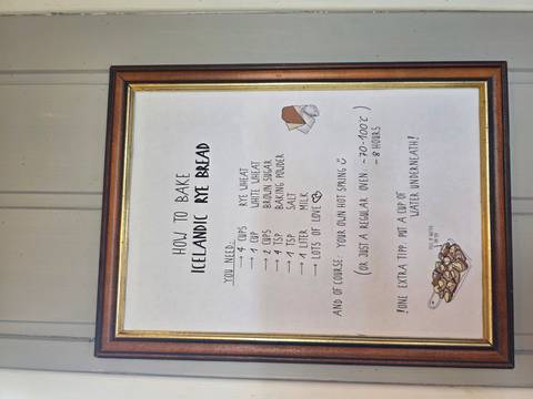 Framed poster displaying a handwritten recipe for traditional Icelandic rye bread hanging on a wooden wall.