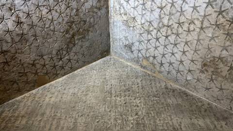 Interior pyramid walls covered with star and hieroglyph patterns at Saqqara.