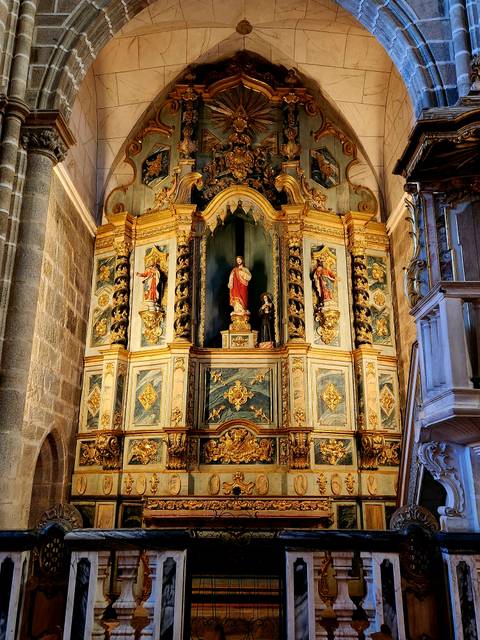 Richly gilded church altar with statues and intricate woodwork