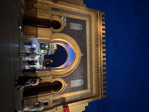 Night scene of the illuminated Blue Gate (Bab Bou Jeloud) entrance to Fes medina.