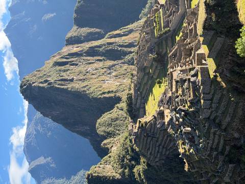 Iconic view of Machu Picchu ruins with towering Huayna Picchu peak framed by Andean mountains