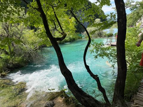 Emerald river and cascades surrounded by lush greenery at Plitvice Lakes