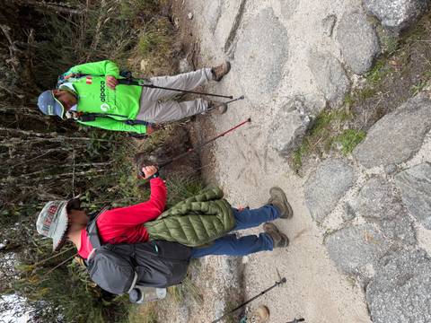 Guide and trekker discussing the path while standing on a stone Inca trail