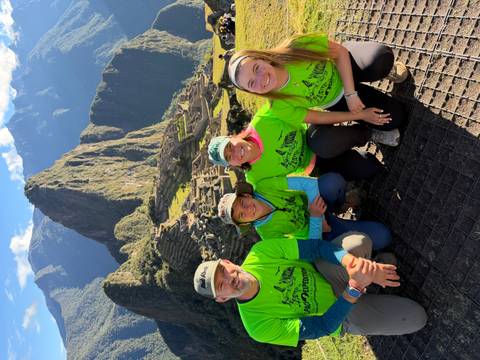 Family portrait with awe-inspiring view of Machu Picchu citadel and Huayna Picchu mountain