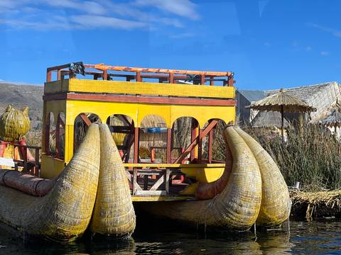 Bright yellow reed boat with dragon prow on Lake Titicaca’s floating Uros Islands