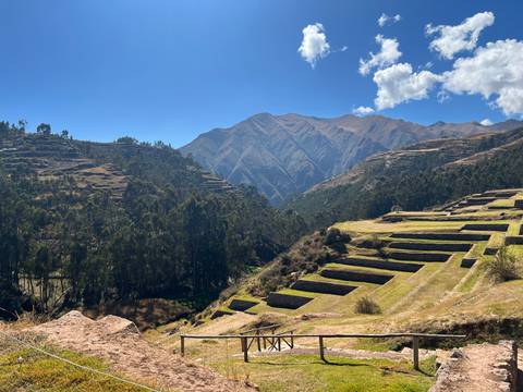 Terraced Inca agricultural site set among wooded valleys and high Andean peaks