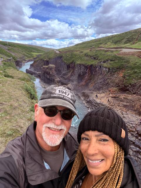 Selfie with rugged canyon walls and a turquoise river snaking through below