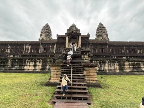 Tourists descending the central staircase of Angkor Wat main building