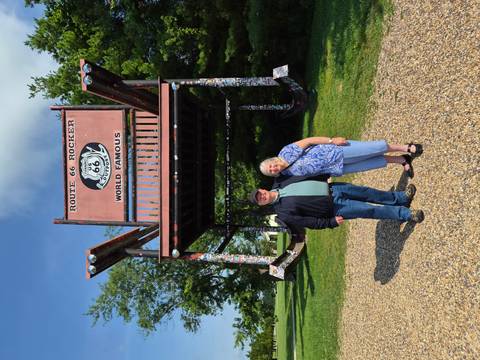 Travellers stand beneath the gigantic Route 66 rocking chair roadside attraction.