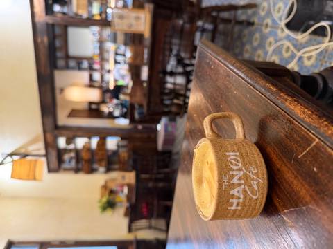 Close-up of a cappuccino in a rustic café with blurred interior shelves in the background