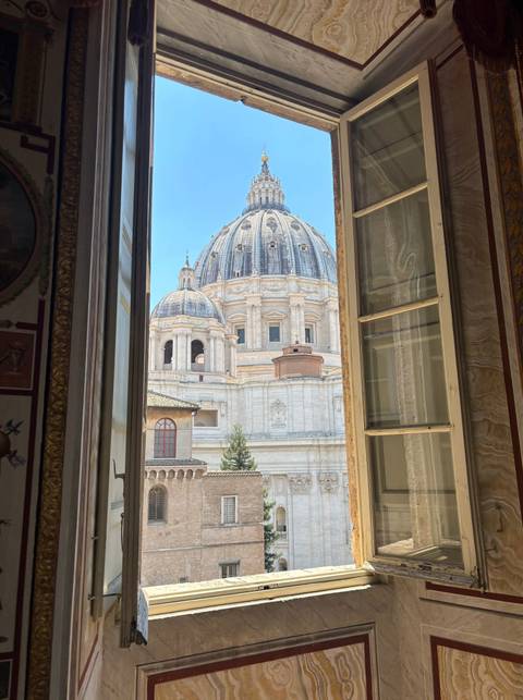 St. Peter’s Basilica dome beautifully framed by an open palatial window