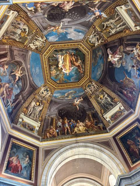 Richly painted Renaissance ceiling with mythological scenes and ornate gold detailing in the Vatican Museums