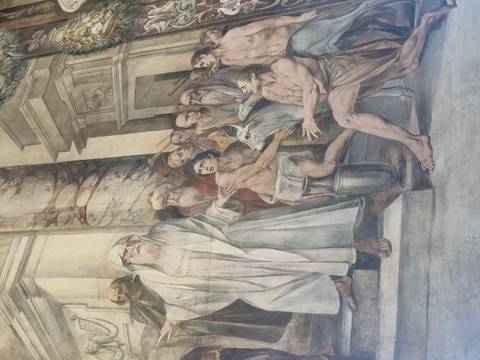 Large monochrome fresco depicting robed figures and animals inside an Italian basilica.