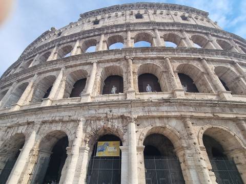 Upward angle of the Colosseum’s arches revealing its massive stone structure.