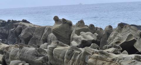 Striking eroded rock formations by the sea with gentle waves in the distance
