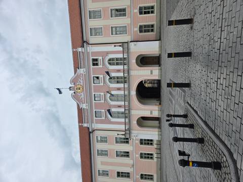 Pink-fronted Toompea Castle, seat of Estonia's parliament, faces an empty cobbled courtyard.