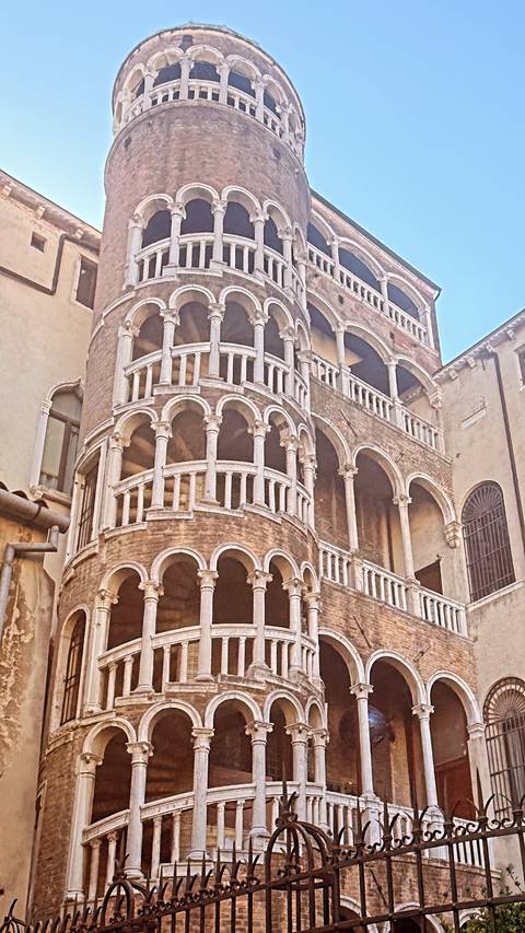 Historic brick palace in Venice featuring the spiral arches of Scala Contarini del Bovolo.