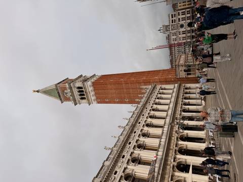 Visitors gather in the piazza beneath St Mark’s Campanile and the historic buildings of Venice.