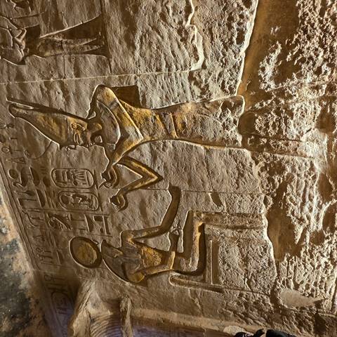 Close-up of deep relief depicting ancient Egyptian deity on temple wall