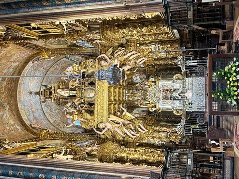 Opulent gilded baroque altar and nave inside Santiago de Compostela Cathedral.