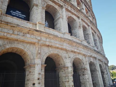 Close-angle architectural detail of the Colosseum’s arches and travertine stone in sunlight