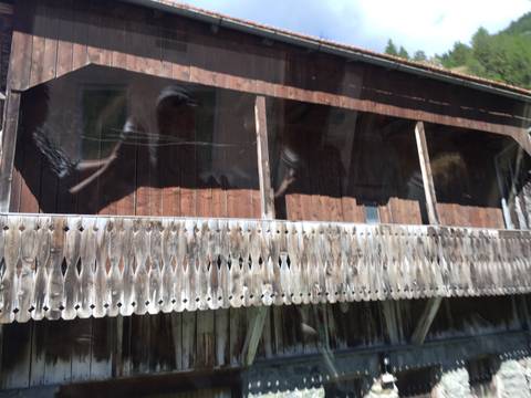 Motion-blurred shot of a rustic wooden balcony taken through a vehicle window