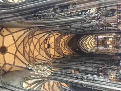 Soaring Gothic interior of St. Stephen's Cathedral with chandeliers and vaulted ceiling