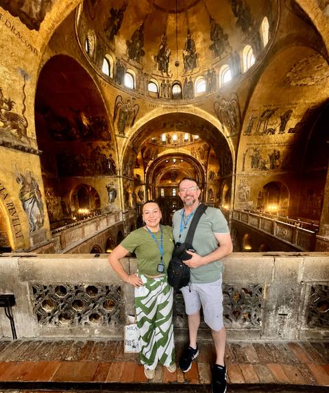 Couple inside the golden mosaicked interior of St Mark's Basilica balcony