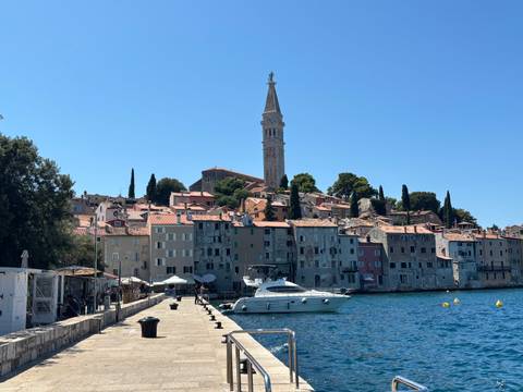 Seaside view of Rovinj’s pastel old town and tall campanile rising above the Adriatic.