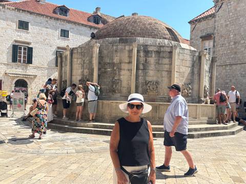 Tourists gather around Dubrovnik’s historic Onofrio Fountain in the old town.