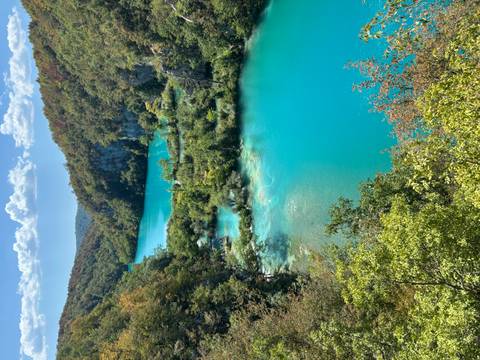 Vibrant turquoise cascades and lush greenery of Plitvice Lakes from an elevated viewpoint.