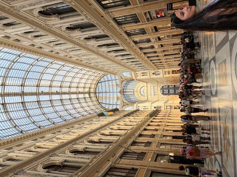 Grand interior of Galleria Umberto I in Naples filled with visitors beneath an arched glass roof