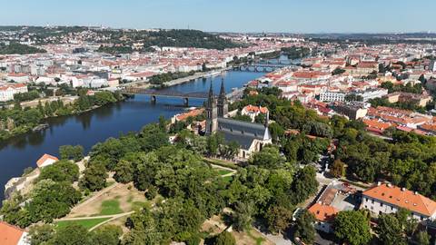aerial view of Prague with Vysehrad Basilica, bridges over the Vltava and sprawling red roofs