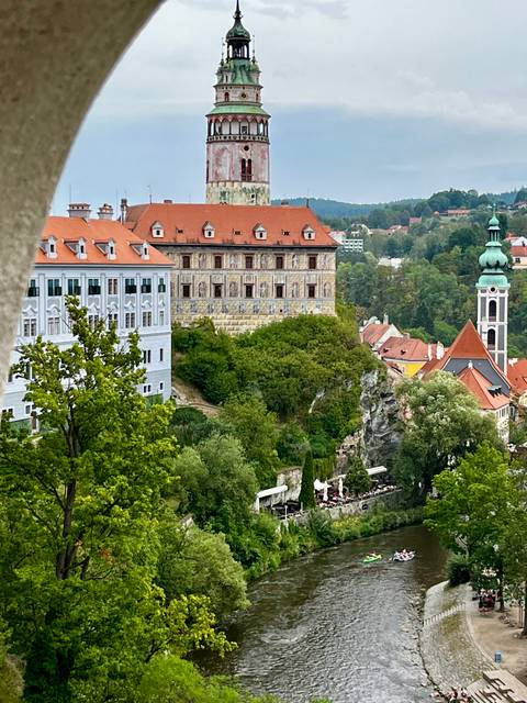 Castle complex and Baroque buildings overlooking forested ravine in Cesky Krumlov