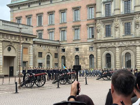 Military band and cannons during ceremonial changing of the guard in the courtyard of Stockholm Royal Palace.