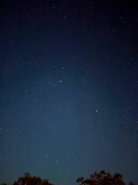 Clear night sky filled with countless stars against a deep blue backdrop.