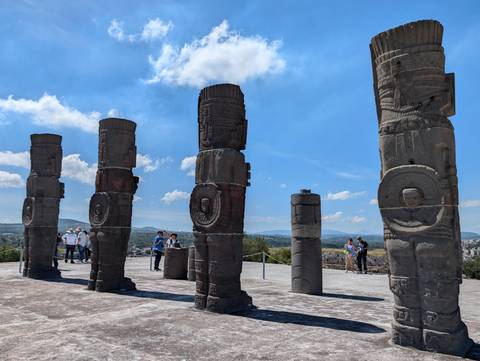Again the towering basalt warrior columns of Tula with tourists exploring the site.