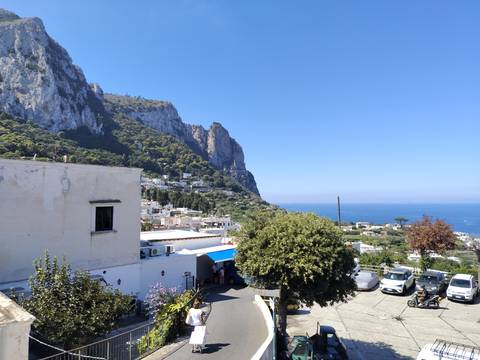Whitewashed houses cling to Capri’s steep limestone cliffs above the sparkling Mediterranean Sea.