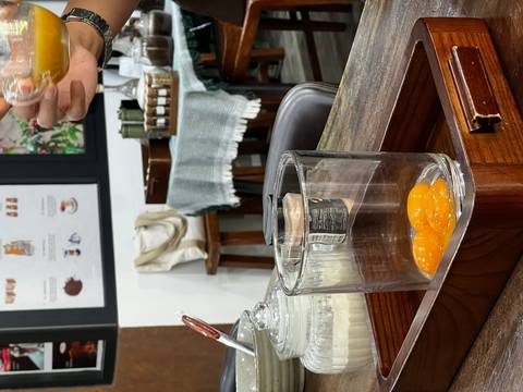 Glass containing raw egg yolks ready for making traditional Vietnamese egg coffee during a workshop.
